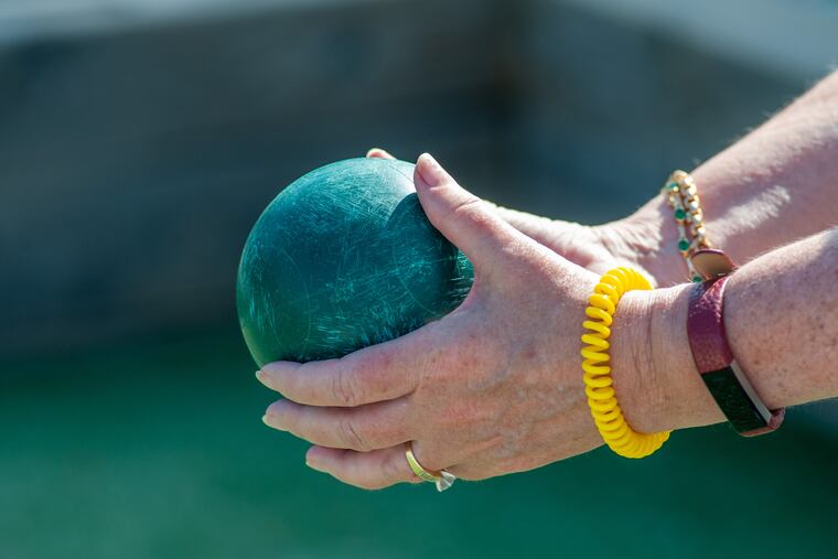 ReRe Boylan of Mill Valley, California takes a shot during a women's bocce league game Wednesday, July 17, 2019 at Stone Harbor Bocce Courts in Stone Harbor, New Jersey. The league has been playing there for 6 years. Their games are played Wednesdays at 9am and 10am. WILLIAM THOMAS CAIN / For The Inquirer