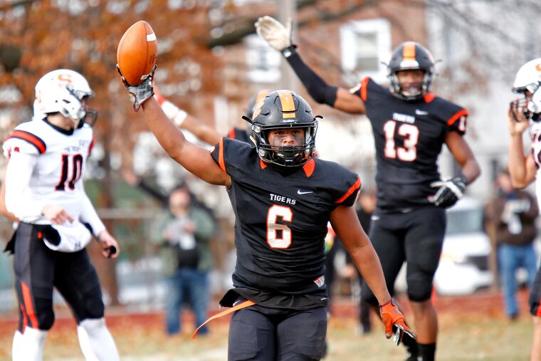 High school football is still planned for this fall in New Jersey. Here, Woodrow Wilson linebacker Dawuh Shakir holds up the ball after recovering a fumble.