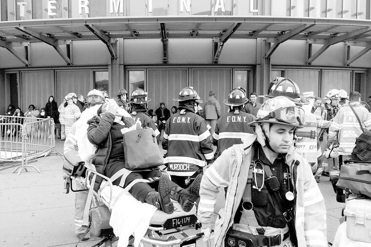 An injured passenger from a derailed Long Island Rail Road commuter train is taken from the Atlantic Terminal in Brooklyn after a crash on Jan. 4, 2017, above.