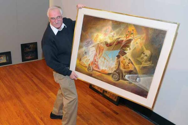 Peter Dajevskis, son of Latvian artist Evald Dajevskis, holds and explains a 1975 painting by his dad titled The Dreadnought to Maija Mednis, 79, on Jan. 24, 2013 at the Latvian Society in Philadelphia where a show of some of Dajevskis' artwork is being hung. Ms. Mednis is a native Latvian living in Blackwood, NJ. She was placed in a "displaced persons camp" during WWII and show theater shows in the camp whose sets were designed by the artist Evald Dajevskis. ( CLEM MURRAY / Staff Photographer )