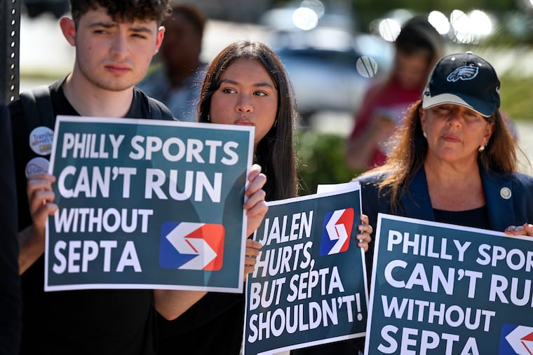 Alex Mingioni (left) and Sayta Adiba (center) stand with State Rep. Lisa Borowski during a September news conference outside SEPTA’s NRG Station at the South Philadelphia sports complex in support of a transit funding bill.