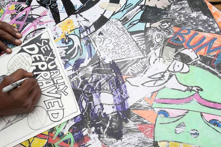 Rob Woods working on the drawing table at Locust Moon Comics that was photographed for the cover of his debut comic book, "36 Lessons in Self-Destruction," released last month. (CHARLES FOX/Staff Photographer )