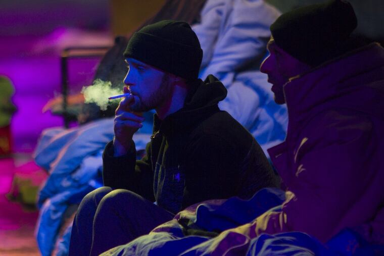 Richard Duncan, left, of South Philadelphia, visits a friend who has been sleeping in the open this week under a bridge at Frankford and Lehigh Avenues in Kensington.