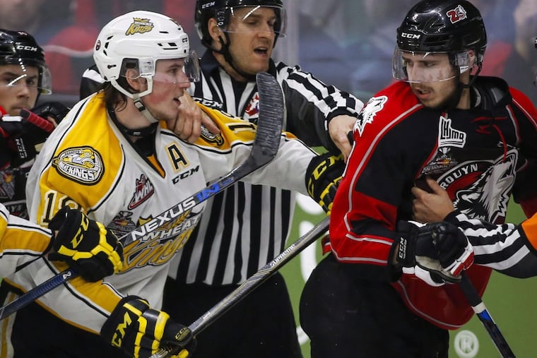 Nolan Patrick (left) of the Brandon Wheat Kings and Anthony-John Greer of the Rouyn-Noranda Huskies are separated as they scuffle during third period CHL Memorial Cup hockey action in Red Deer on May 21, 2016.