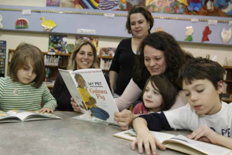 From L to R: Katie Erb, 6, Principal Anna Jenkins, Kelly Phillips Erb, Lisa Lobitz-Ashenfelter and daughter Madeline Ashenfelter, 6, and Jake Ashenfeler, 8, at Cook-Wissahickon Elementary. ( Charles Fox / Staff Photographer )
