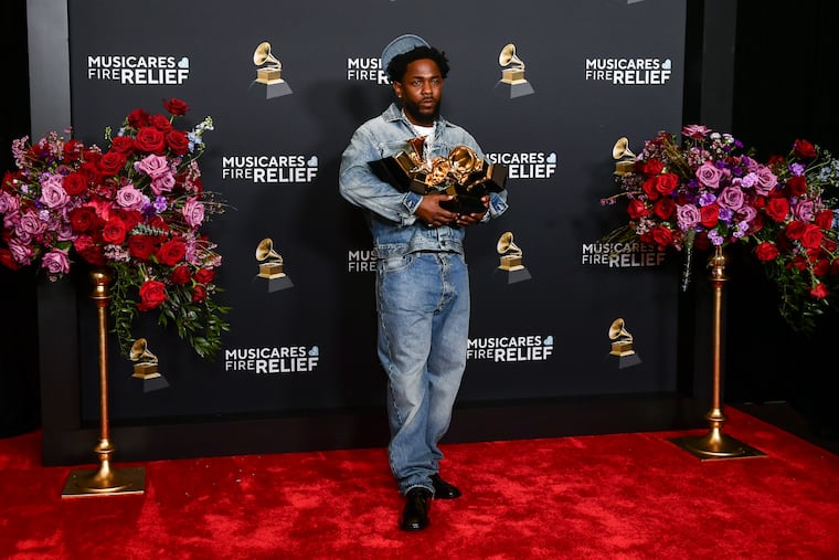 Kendrick Lamar poses in the press room with the award for record of the year, best rap performance, best rap song, best music video and song of the year during the 67th annual Grammy Awards on Sunday. He will perform the Super Bowl LIX halftime show.