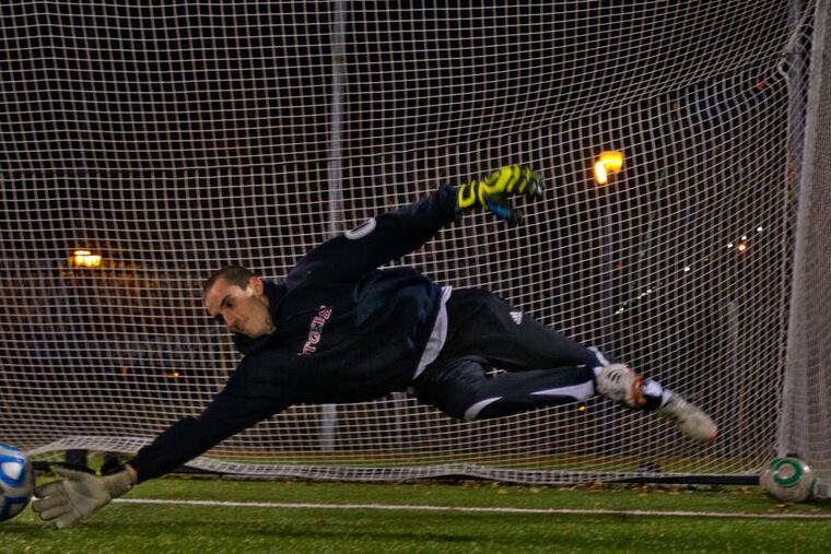 Goalie Mike Randall stops a shot during the team's practice on Monday.
