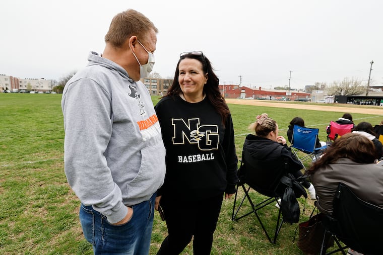 John DeRenzi stands with his wife, Beth, before a Neumann Goretti baseball game. John DeRenzi had kidney transplant made possible through the connections of the Neumann Goretti baseball program.