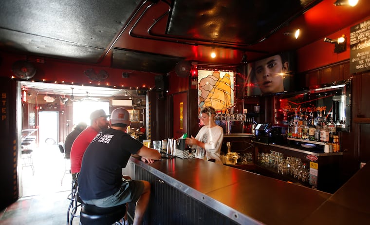Patrons sit at the Fishtown Tavern bar as bartender Marykate Breslin (right) prepares a drink on Thursday, September 2, 2021.