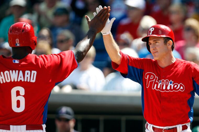 Ryan Howard (right) and Chase Utley celebrate during a game in February. (David Maialetti/Staff Photographer)