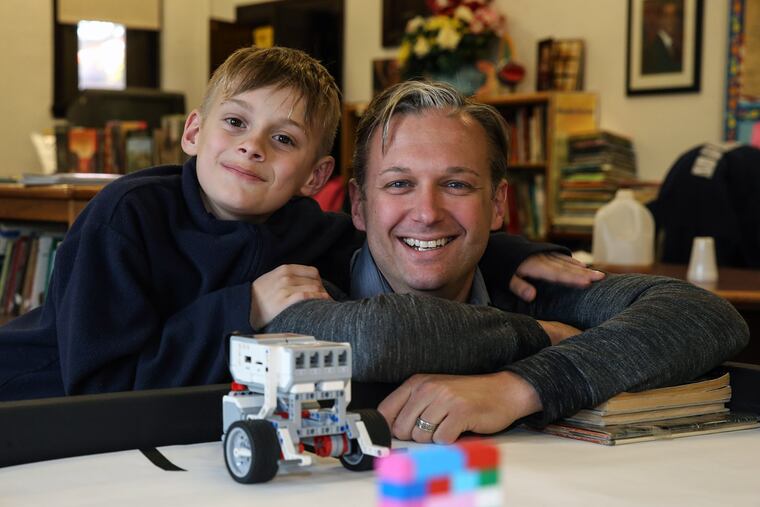 Henry Scott, shown with dad Mark, started a petition to keep a beloved teacher at E.M. Stanton Elementary.