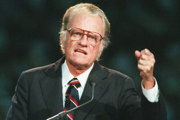 In this October 26, 1994 file photo, Evangelist Billy Graham begins his sermon in Atlanta’s Georgia Dome. Graham, who transformed American religious life through his preaching and activism, becoming a counselor to presidents and the most widely heard Christian evangelist in history, has died. Spokesman Mark DeMoss says Graham, who long suffered from cancer, pneumonia and other ailments, died at his home in North Carolina on Wednesday, Feb. 21, 2018. He was 99.