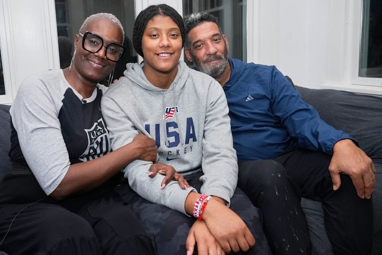 Laila Edwards (center) will become the first Black woman to suit up for Team USA in Olympic women's hockey. Her parents, Charone Gray-Edwards (left) and Robert Edwards, will get to see her in person thanks partially to a donation from some fellow Cleveland Heights natives.