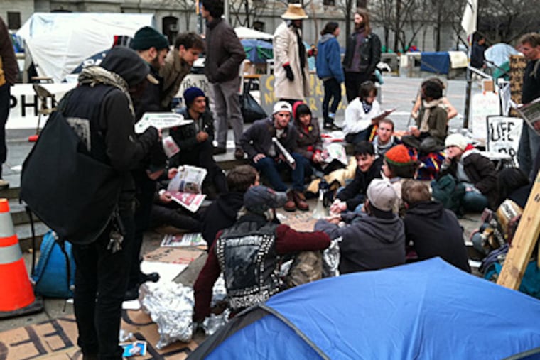 Occupy protestors gathered outside City Hall on the morning of Nov. 28, 2011, a day after a deadline to leave Dilworth Plaza. (Peter Mucha/Staff)