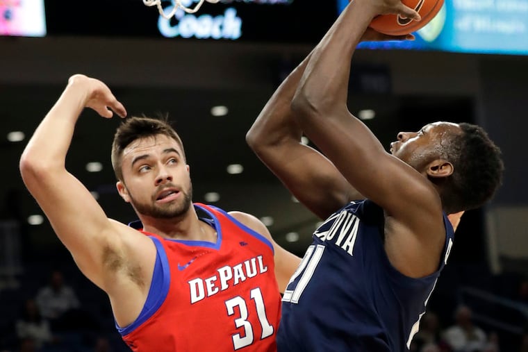 Villanova forward Dhamir Cosby-Roundtree, right, shoots against DePaul guard Max Strus during the first half of an NCAA college basketball game Wednesday, Jan. 30, 2019, in Chicago. (AP Photo/Nam Y. Huh)