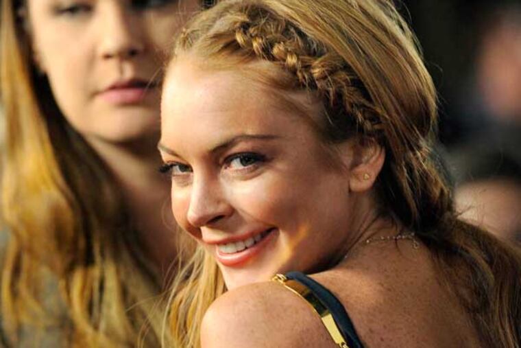 FILE - This April 11, 2013 file photo shows actress Lindsay Lohan, a cast member in "Scary Movie V," at the premiere of the film in Los Angeles. Lohan's lawyer Mark Jay Heller told a judge at a May 2, 2013 hearing that Lohan had checked into a rehab facility per a judge's orders. (Photo by Chris Pizzello/Invision/AP, file)