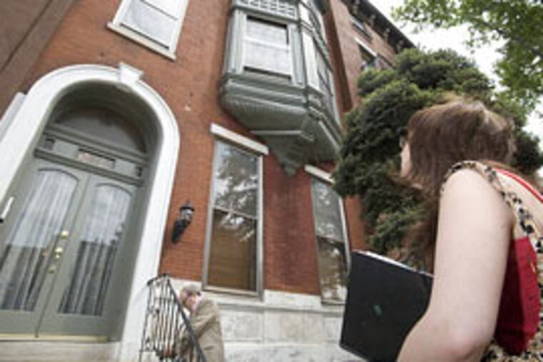 Student Megan Berry checks out the exterior of a condominium she considered renting.