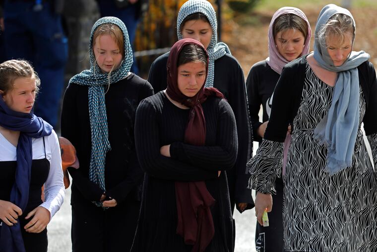 Mourners leave the cemetery after the burial service of the body of a victim of the Friday, March 15, 2019, mosque shootings at the Memorial Park Cemetery in Christchurch, New Zealand, Thursday, March 21, 2019.