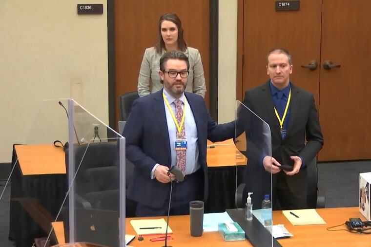 In this screen grab from video, defense attorney Eric Nelson, left, defendant Derek Chauvin, right, and Nelson's assistant Amy Voss, back, introduced themselves to potential jurors on Tuesday.