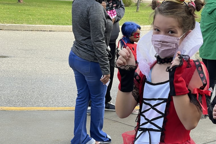 Alison McCook's daughter marches in her school's costume parade in 2021. It's the only one McCook has attended so far; she missed the other parade because she couldn't get off work.