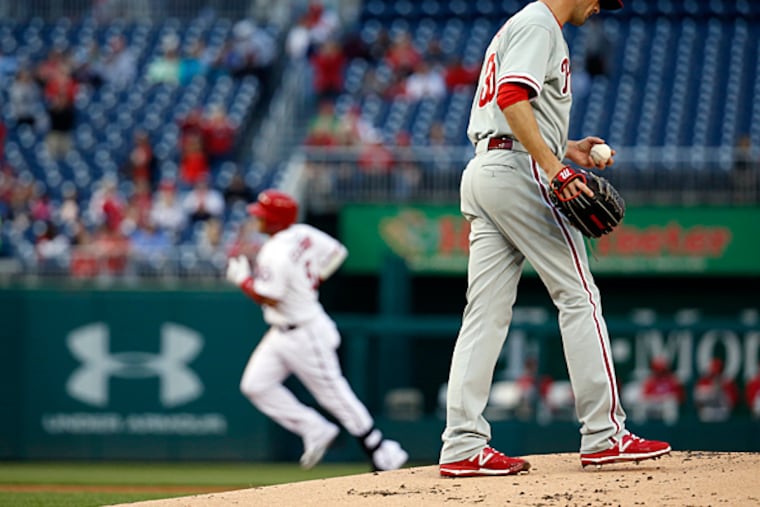 Philadelphia Phillies starting pitcher Cole Hamels walks to the mound as Washington Nationals' Yunel Escobar rounds the bases on a solo home run during the first inning of a baseball game at Nationals Park, Thursday, April 16, 2015, in Washington. (AP Photo/Alex Brandon)