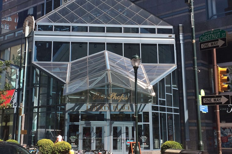 The entrance to the Shops at Liberty Place on 16th Street, whose canopy reflects the crowns on the towers.