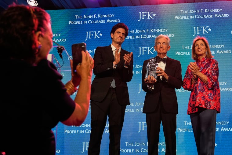 Federal Reserve Board Governor Jerome Powell, the former Federal Reserve chair, center, stands with former ambassador Caroline Kennedy, right, and her son Jack Schlossberg, as Powell's wife Elissa Leonard takes a picture at left, at a ceremony for the Profile in Courage Awards at the John F. Kennedy Presidential Library, Sunday, May 31, 2026, in Boston.