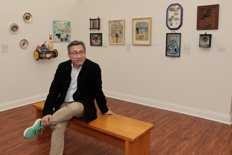 Tu Huynh, City Hall's curator of exhibitions and programs, sits in his office, surrounded by art fashioned from found objects, part of "Made and Remade — The Art of Philadelphia Dumpster Divers."