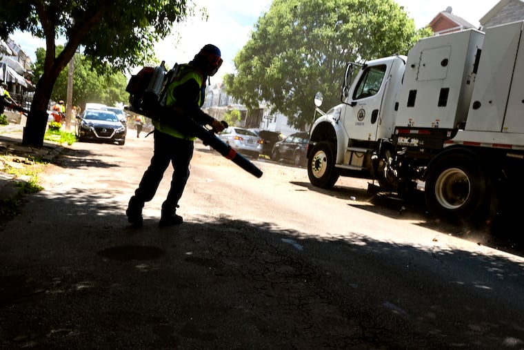 Streets Department workers, part of Mayor Parker's āClean and Greenā initiative, are on task at South 55th and Elliot Streets in Kingsessing on July 1, 2024.