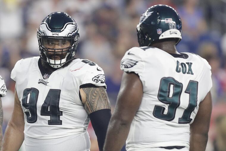 Eagles defensive tackle Haloti Ngata (center) with teammates defensive end Derek Barnett (left) and defensive end Fletcher Cox during a preseason game against the New England Patriots at Gillette Stadium in Foxborough, MA on Thursday, August 16, 2018. YONG KIM / Staff Photographer