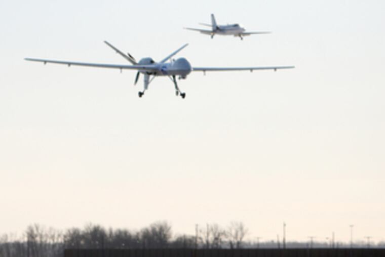 The Predator B drone (left), the first unmanned aircraft system to patrol the northern U.S. border, goes in for a landing after yesterday's six-hour flight.