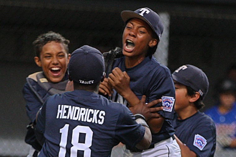 Taney Mo'ne Davis is surrounded by her teammates Scott Bandura, Jahli Hendricks and Jack Rice. (Michael Bryant/Staff Photographer)