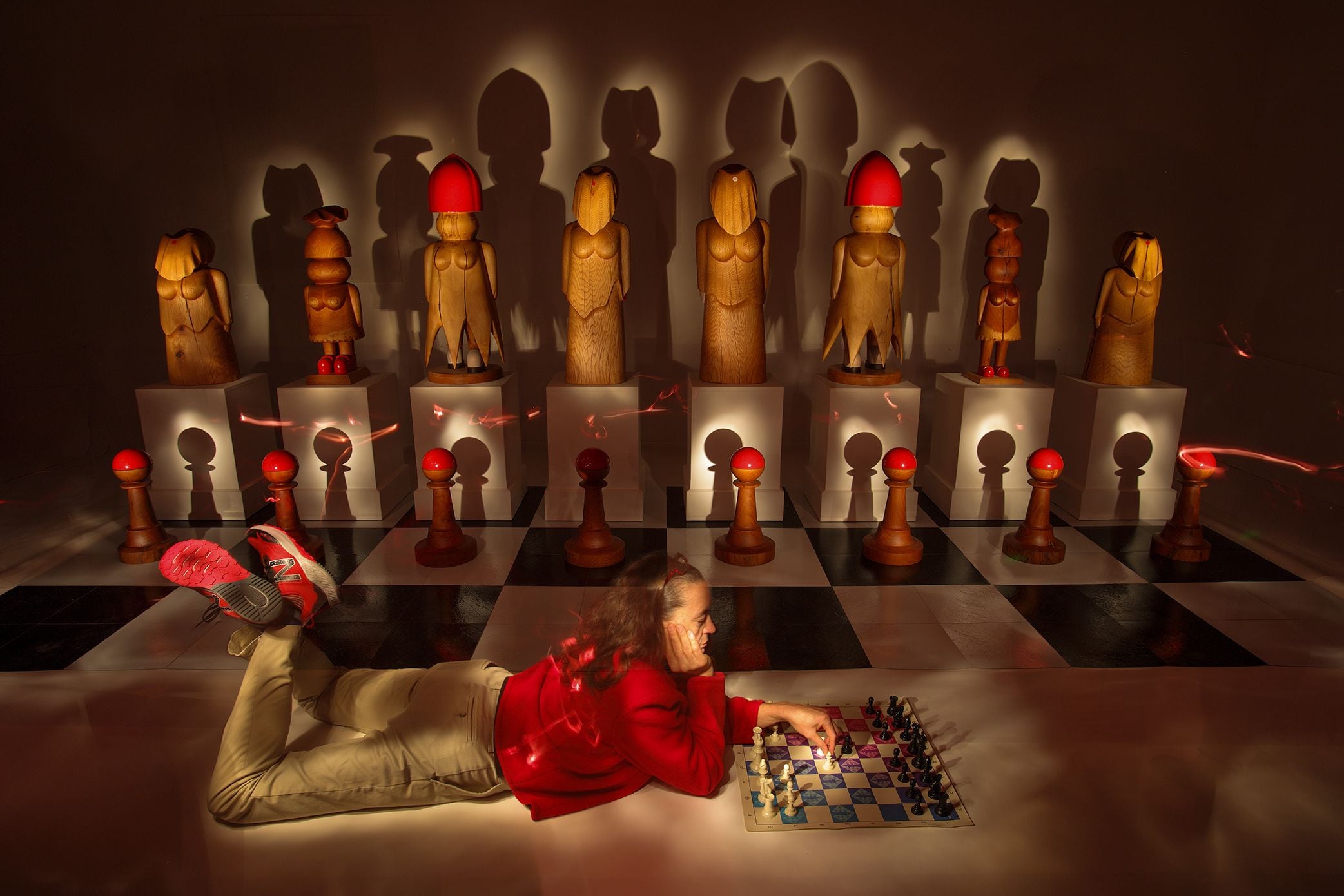 A large chess board with life-size pieces is posing questions about gender roles and hierarchy