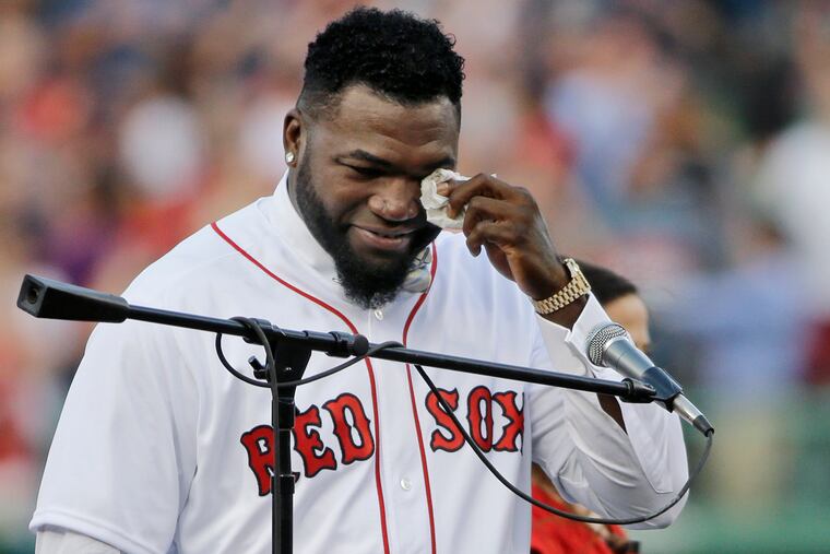 FILE - In this June 23, 2017, file photo, Boston Red Sox baseball great David Ortiz wipes a tear at Fenway Park in Boston as the team retires his number "34" worn when he led the franchise to three World Series titles. Ortiz was back in Boston for medical care after authorities said the former Red Sox slugger affectionately known as Big Papi was ambushed by a gunman at a bar in his native Dominican Republic. A plane carrying the 43-year-old retired athlete landed Monday night, June 10, 2019, after a flight from the Dominican Republic, the team said.