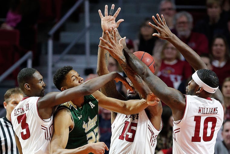 USF's Angel Nunez gets triple teamed by Temple's Levan Shawn Alston Jr., Jaylen Bond and Mark Williams.