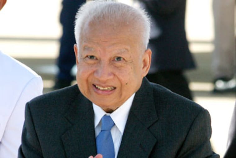FILE - In this Sept. 2, 2006 file photo, Cambodia's retired King Norodom Sihanouk greets well-wishers before departing for China from Phnom Penh International Airport, in Cambodia. Sihanouk, the former Cambodian king who was never far from the center of his country's politics through a half-century of war, genocide and upheaval, has died. He was 89. (AP Photo/Heng Sinith, File)