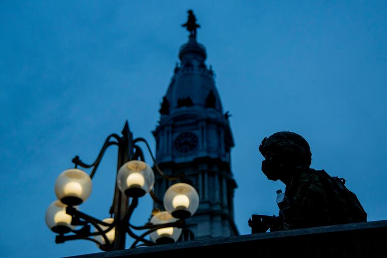 A Pennsylvania National Guard member is on duty at the Municipal Services Building plaza as the sun sets on a sixth day of marching and protests June 4, 2020. Demonstrations continued in the city following the death of George Floyd in Minneapolis.