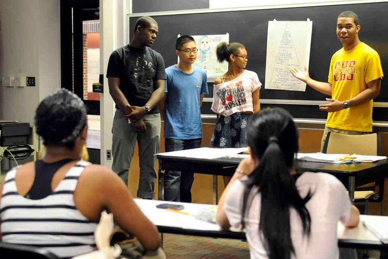 During a presentation at the Wharton program, Ramon Guzman-Segura addresses the class. Also on his team are (from left) Cornelius Brown, Jason Zheng, and Brianna Stokes.