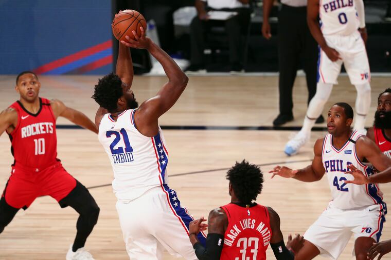 Joel Embiid (21) shoots over Houston's Robert Covington (33) during the first half of the Sixers' and Rockets' seeding game finale Friday night. (Kim Klement / USA Today Sports via AP Pool)