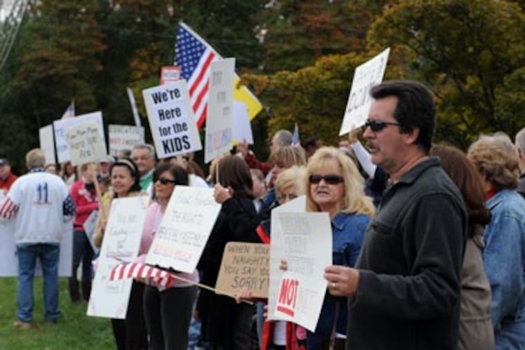 Protesters stage a rally outside of B. Bernice Young Elementary School for concerns over an Internet video showing students singing praise for President Obama, Monday, Oct. 12, 2009 in Burlington Township. (AP Photo/Camden Courier-Post, Douglas M. Bovitt)
