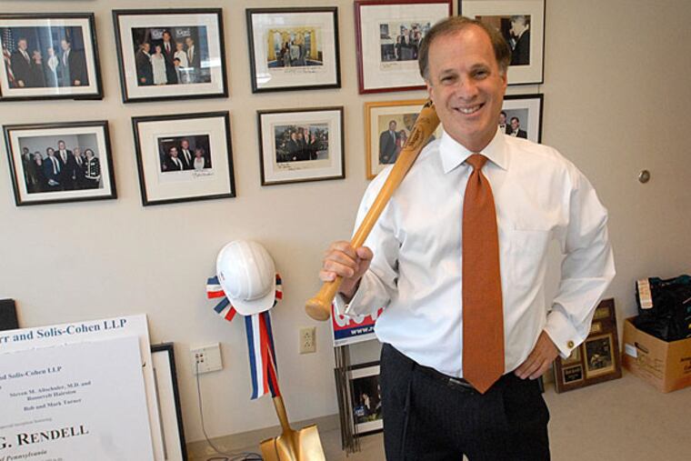Democratic fundraiser Alan Kessler with campaign paraphernalia, including many photos of himself with pols, in his law office. (April Saul/Staff)
