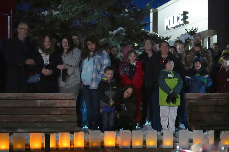 People attend a candlelight vigil after two police officers and a first responder were shot and killed ON Sunday, Feb. 18, 2024, in Burnsville, Minn.