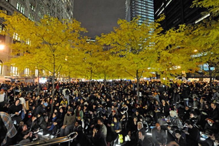 Occupy Wall Street protesters gather to listen to speakers after being allowed back into New York City’s Zuccotti Park Tuesday night. Crowds returning to the park will not be allowed to bring tents and stay, a New York judge ruled. (Henny Ray Abrams / Associated Press)