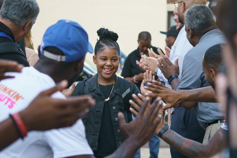 9-year-old student Remiyah Taylor, is greeted by a red carpet and an enthusiastic high-five line of people on the first day of school at Robert Morris Elementary School, in Philadelphia, September 3, 2019.
