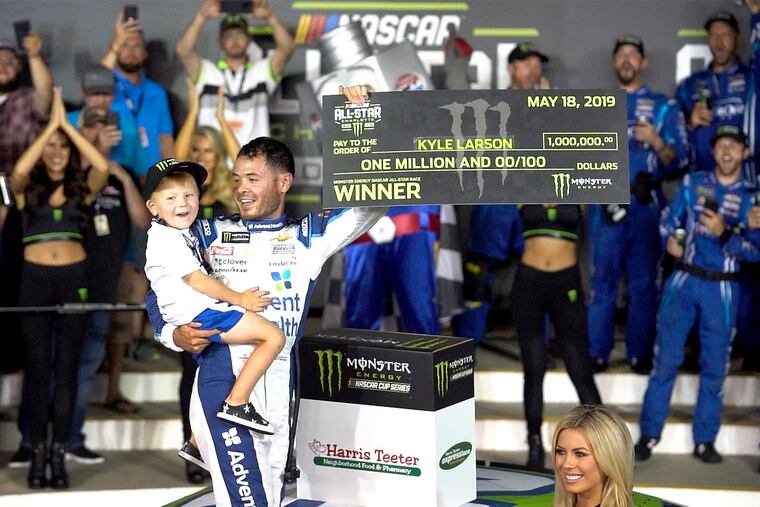 Kyle Larson celebrates with his son Owen after winning the Monster Energy NASCAR All-Star race last Saturday at Charlotte Motor Speedway.