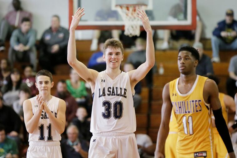 La Salle # 11 Jake Timby applauds while # 30 Konrad Kiszka gets the fans to roar because La Salle has a commanding lead with under a minute to go in the Roman Catholic vs. La Salle H.S. PIAA Class 6A quarterfinal boys basketball game at Archbishop Ryan HS in Phila., Pa. on March 16, 2019. La Salle won the game 55-47.