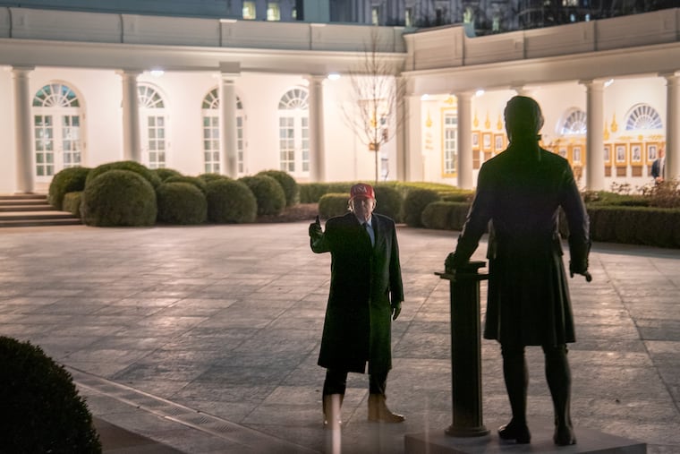 President Donald Trump examines a statue of Alexander Hamilton in the Rose Garden at the White House on March 1. He recently installed another store depicting Thomas Jefferson.