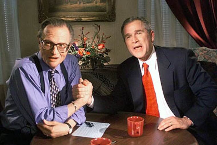 In this Dec. 16, 1999 file photo, Republican presidential candidate George W. Bush jokes with CNN's Larry King. After 25 years of "Larry King Live," King hung up his suspenders. (AP Photo / John Russell)