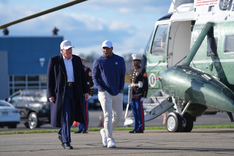 President Donald Trump walks with Saquon Barkley before boarding Air Force One at Morristown (N.J.) Municipal Airport on Sunday.