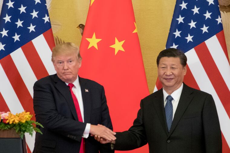 In this Nov. 9, 2017 file photo, President Donald Trump and Chinese President Xi Jinping shake hands during a joint statement in Beijing. The U.S. will impose a 25 percent tariff on $50 billion worth of Chinese goods containing "industrially significant technology."